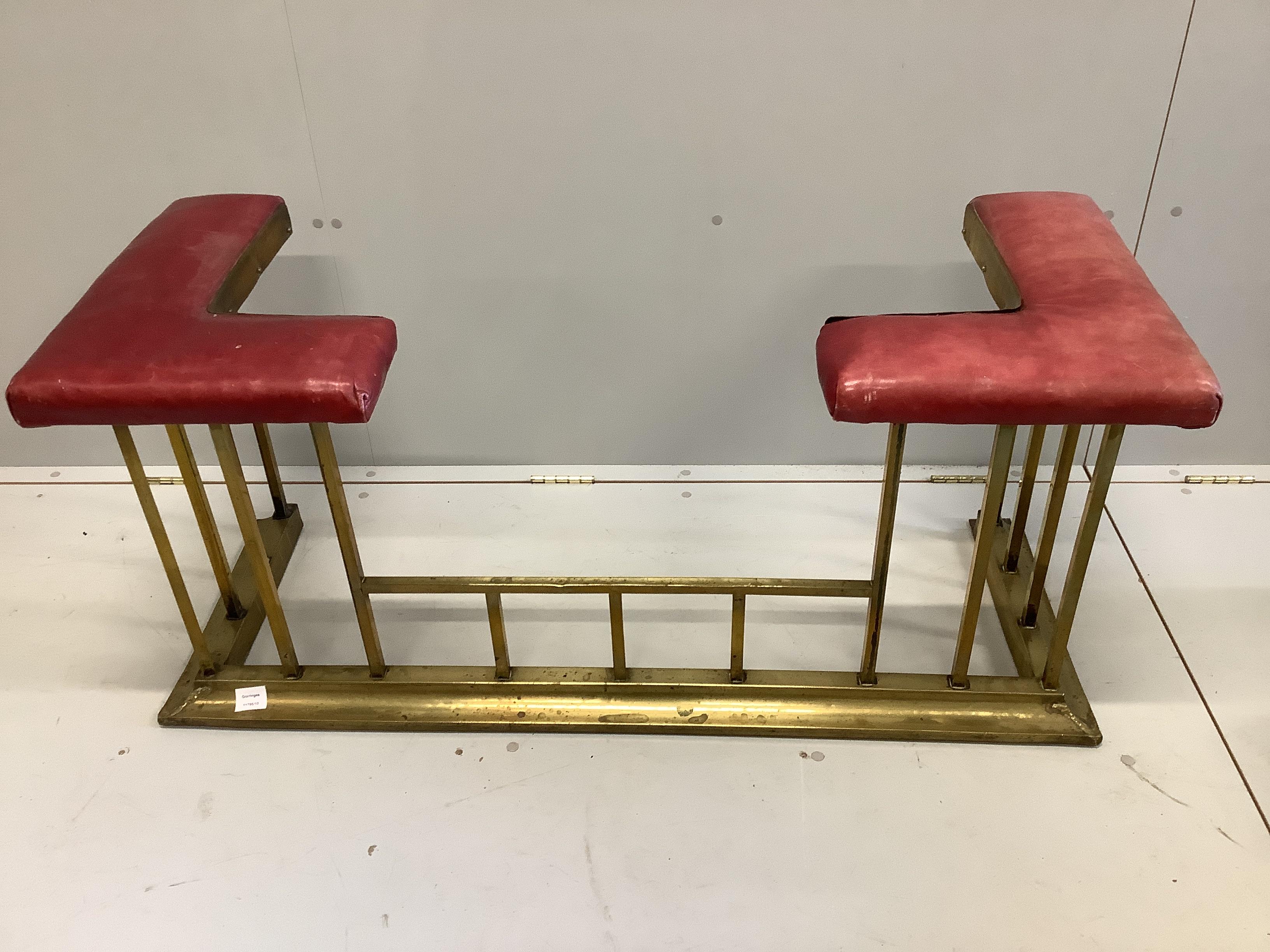 An Edwardian brass and red leather club fender width 122cm, depth 43cm, height 54cm.